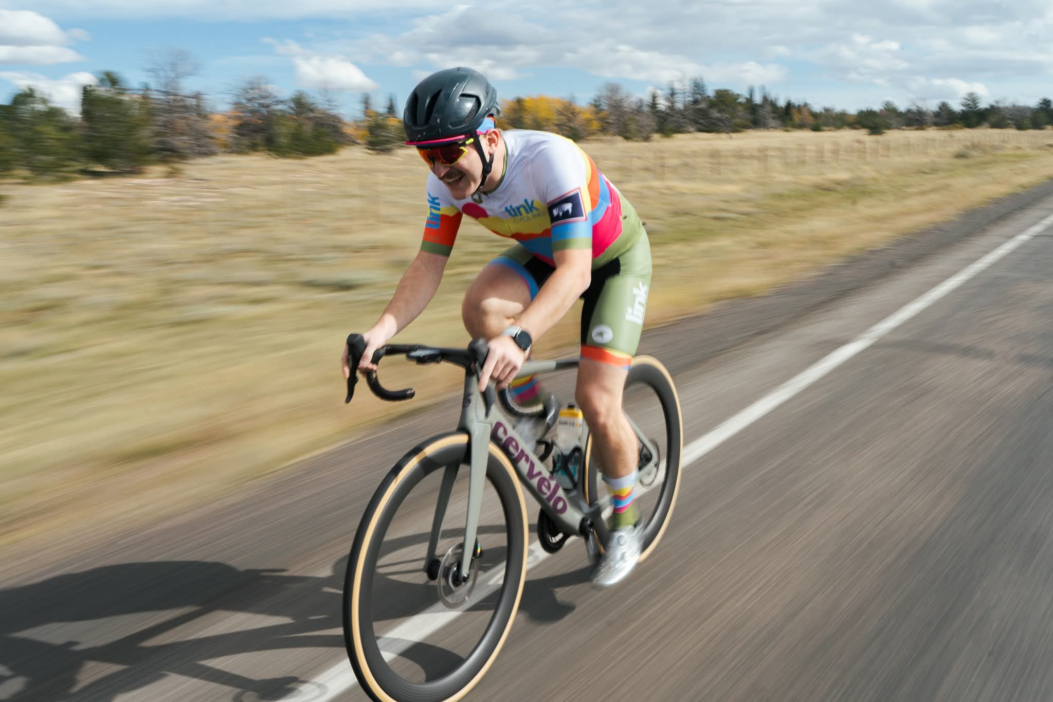 André Fecteau riding a Cervélo in Link Cycling kit on an open road outside Laramie, Wyoming
